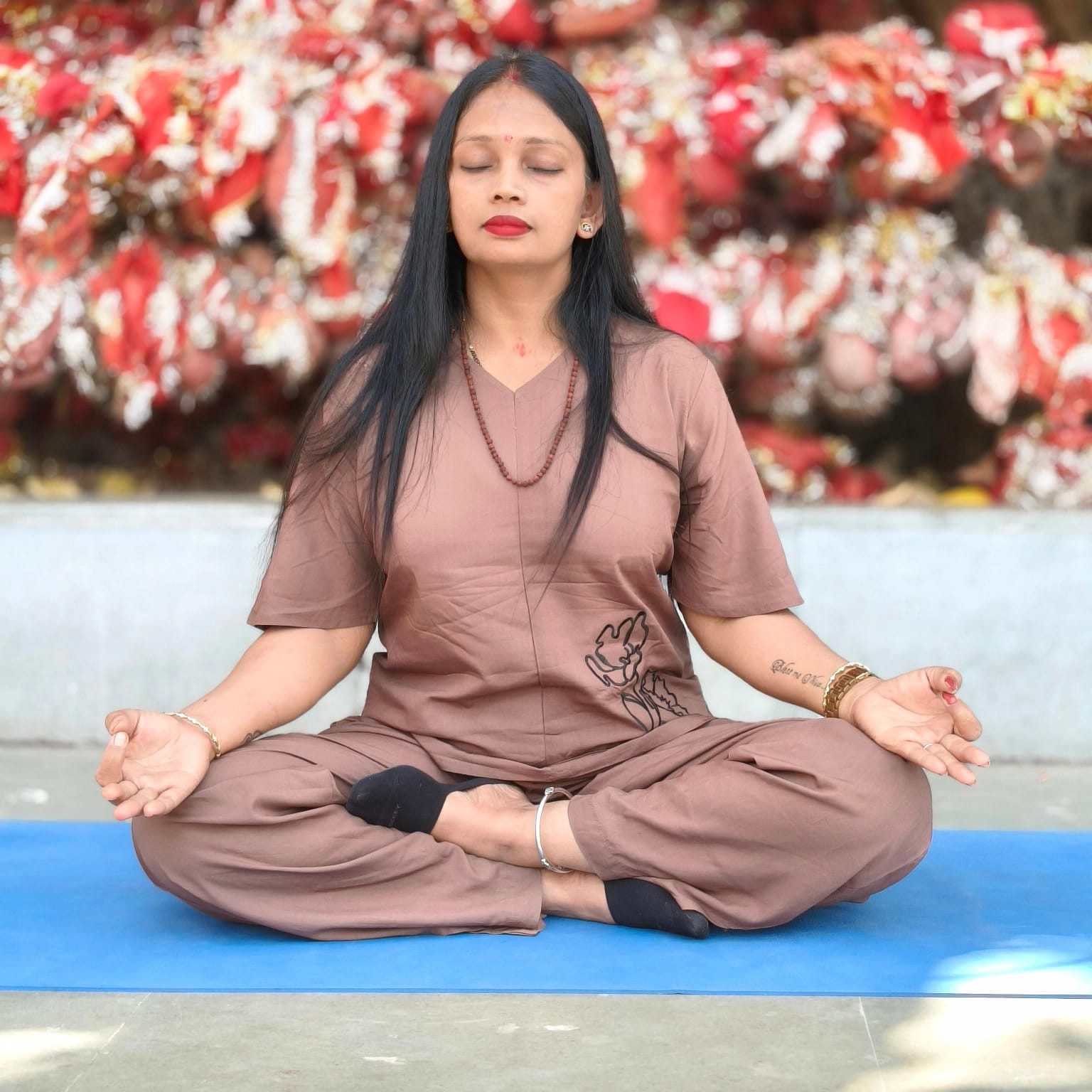 Mrs. Seema Sharma seated in padmasana